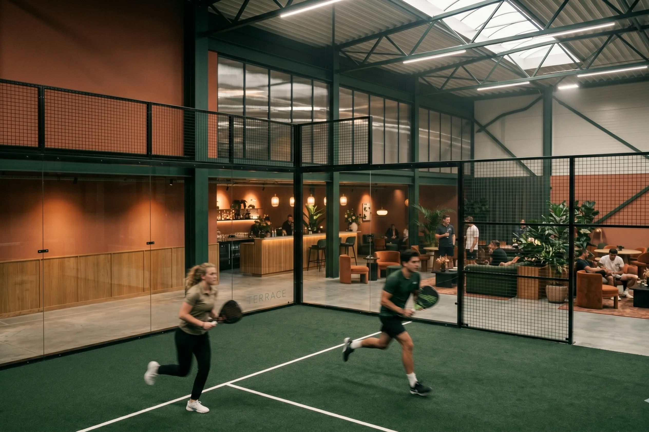 Four junior players on an indoor padel court